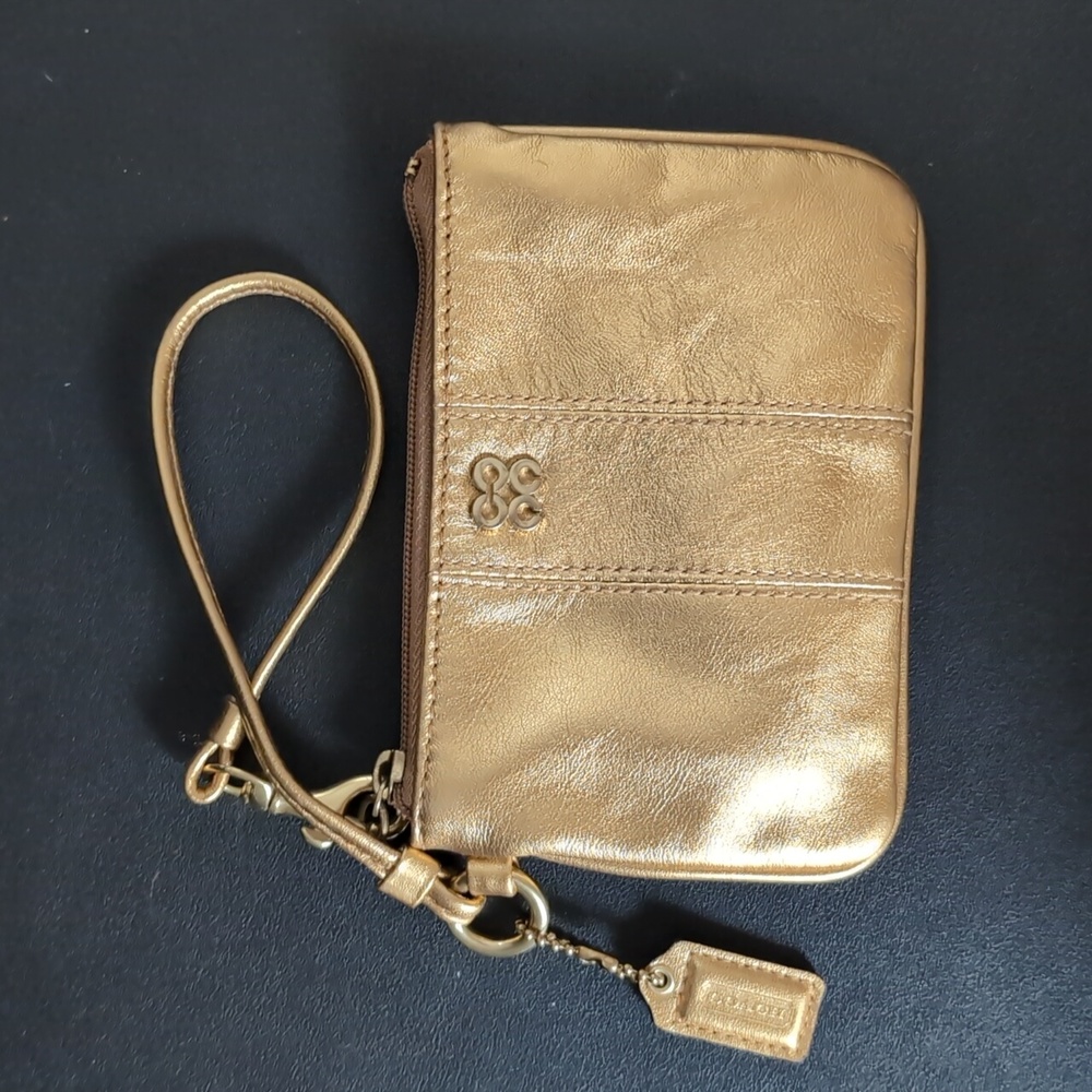 Small gold coach wristlet/clutch